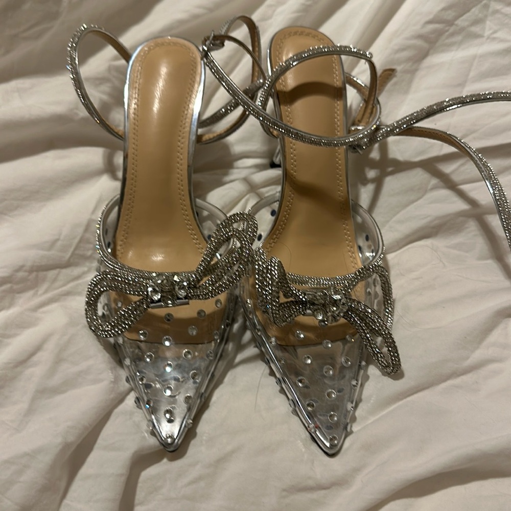 Brand new. Never worn. Strap goes up the ankle.